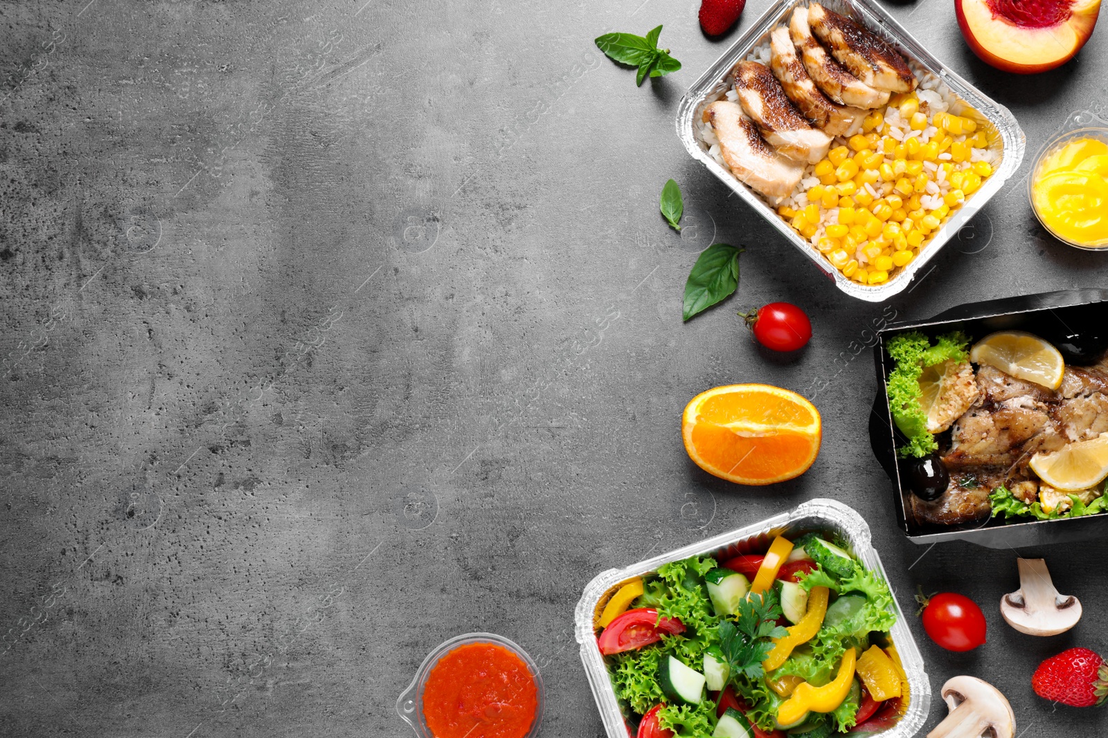 Photo of Lunchboxes on grey table, flat lay. Healthy food delivery