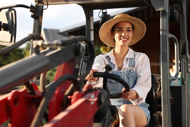 Smiling farmer driving loader outdoors. Agriculture equipment