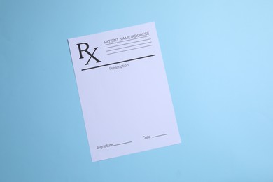 Medical prescription form on light blue background, top view