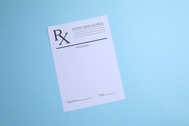 Photo of Medical prescription form on light blue background, top view