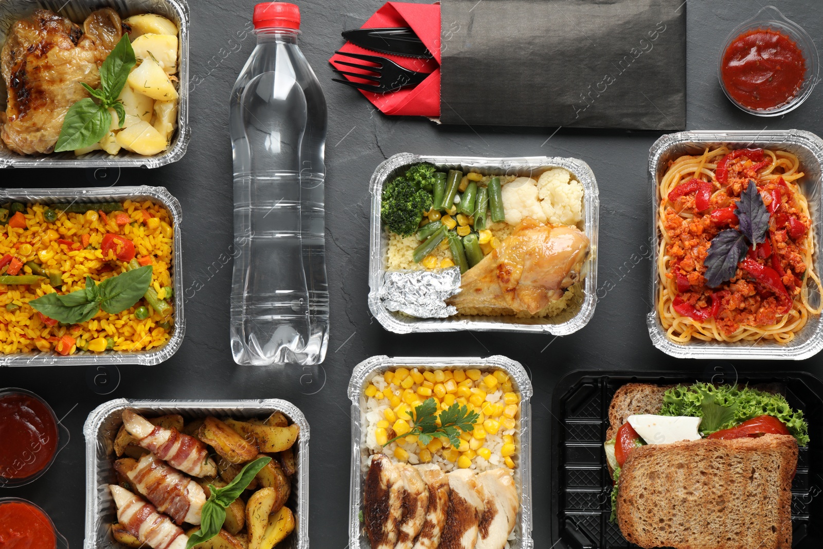 Photo of Lunchboxes on grey table, flat lay. Healthy food delivery