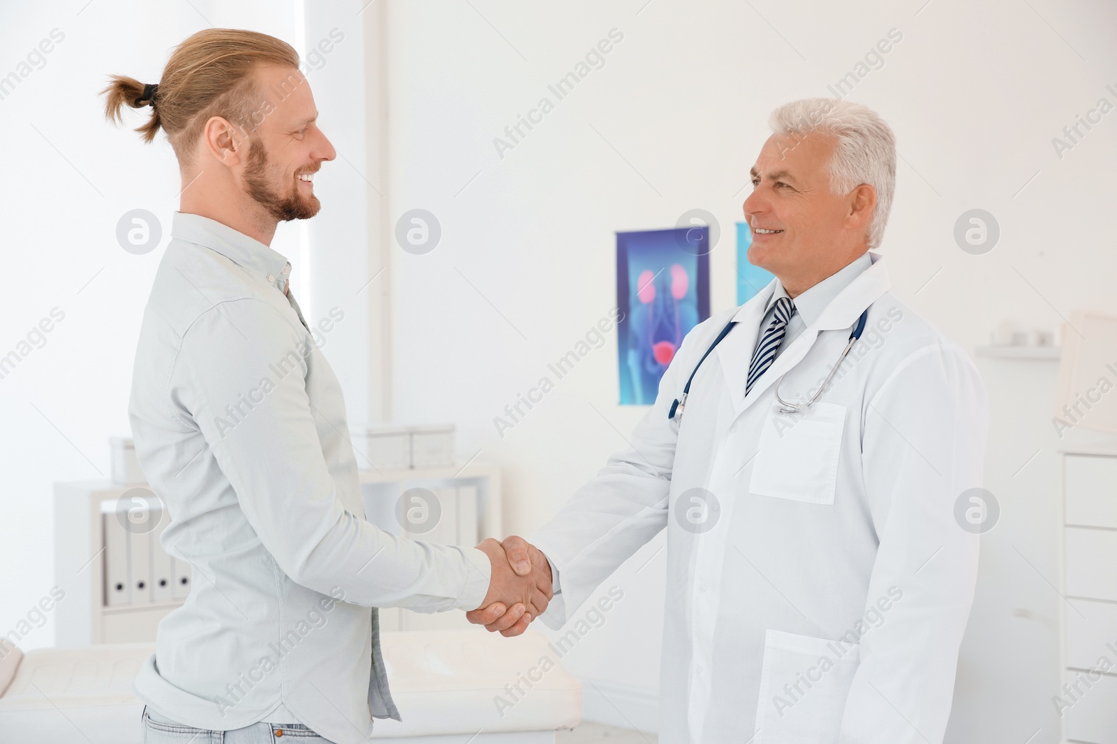 Photo of Urologist and thankful patient shaking hands at hospital