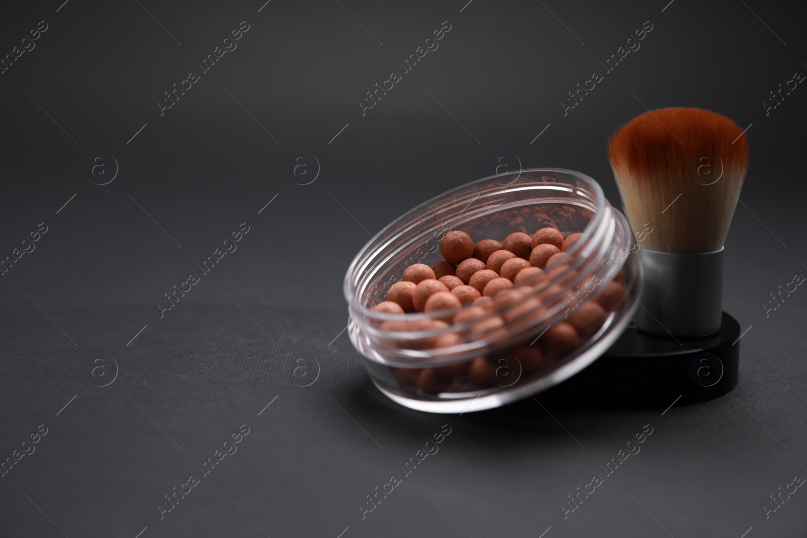 Photo of Face powder and makeup brush on black background, space for text