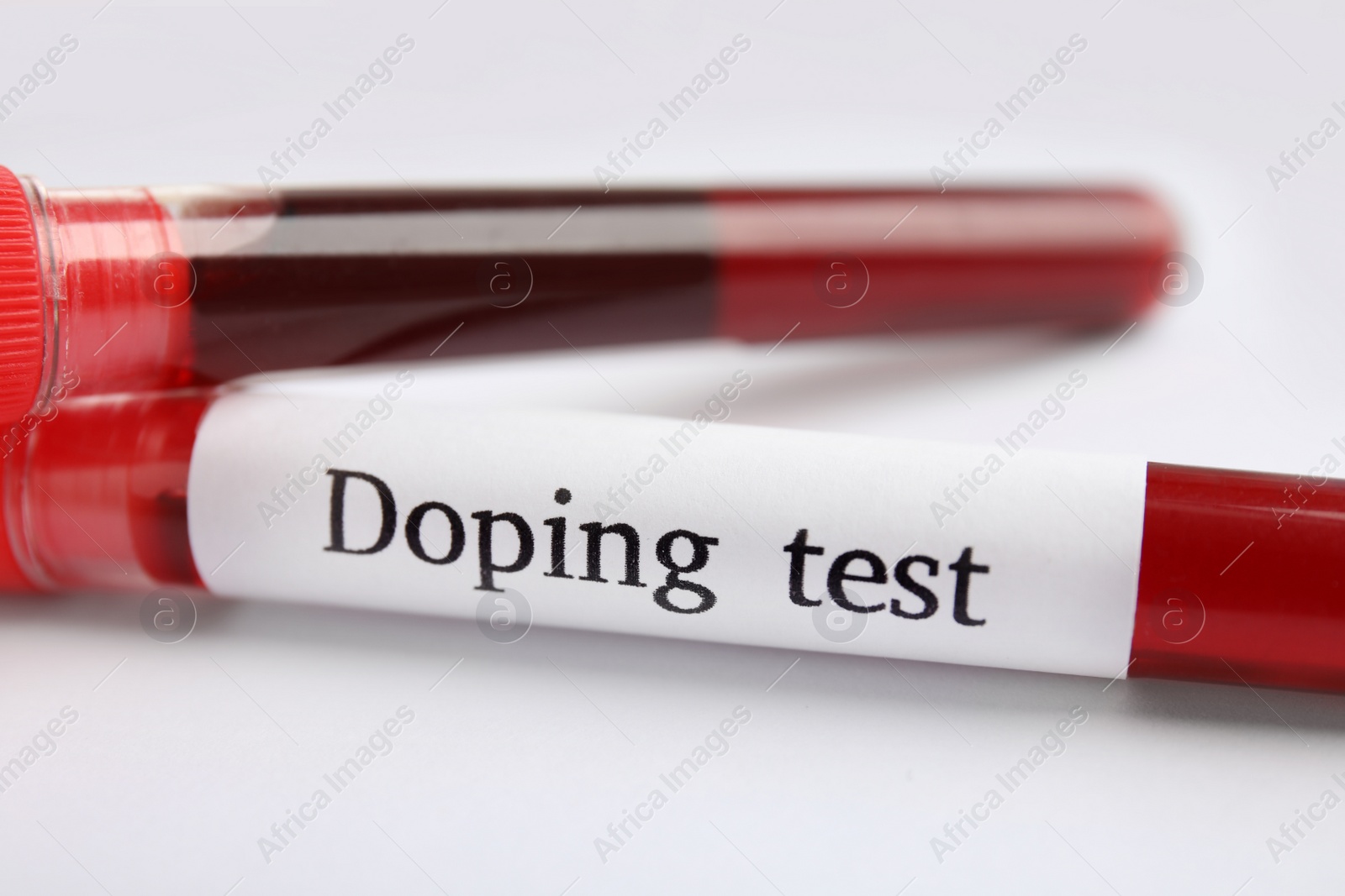 Photo of Test tubes with blood samples on white table, closeup. Doping control