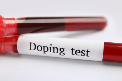 Test tubes with blood samples on white table, closeup. Doping control