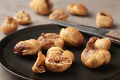 Plate with dried figs on table, closeup. Organic snack