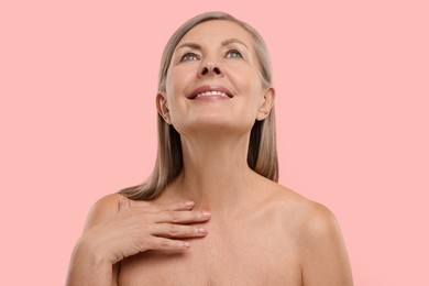 Photo of Beautiful woman with healthy skin on pink background