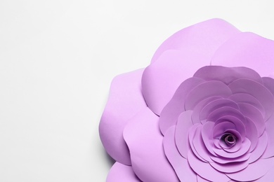 Photo of Beautiful violet flower made of paper on white background, top view