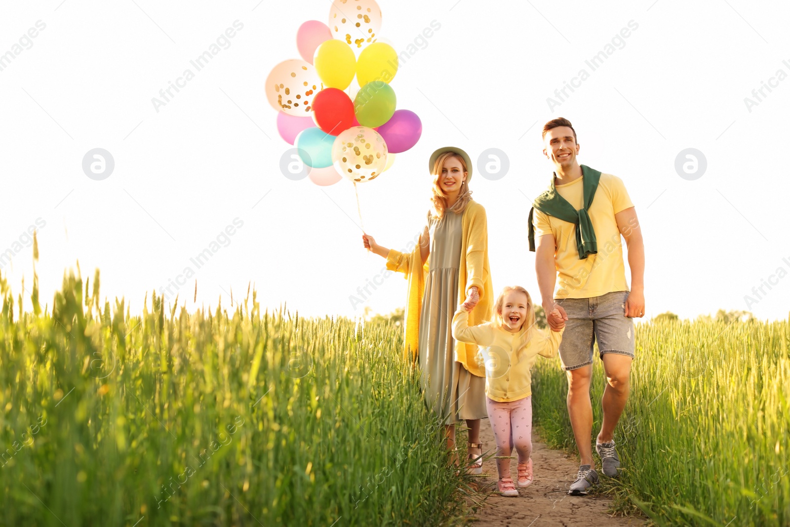 Photo of Happy family with colorful balloons outdoors on sunny day