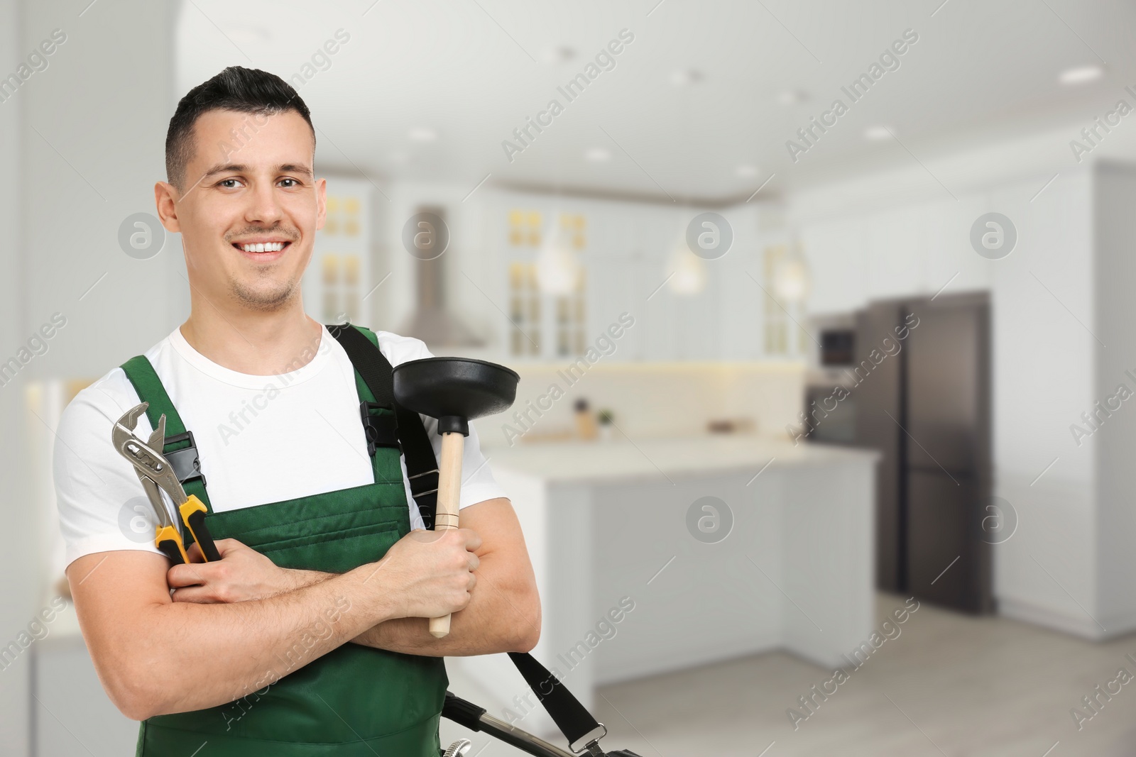 Image of Plumber with adjustable wrench and force cup in kitchen, space for text