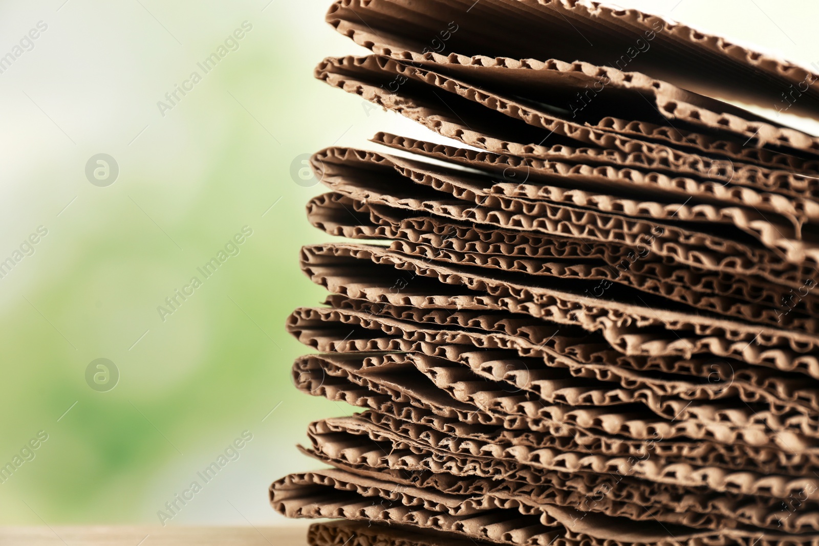 Photo of Stack of cardboard for recycling on blurred background, closeup. Space for text