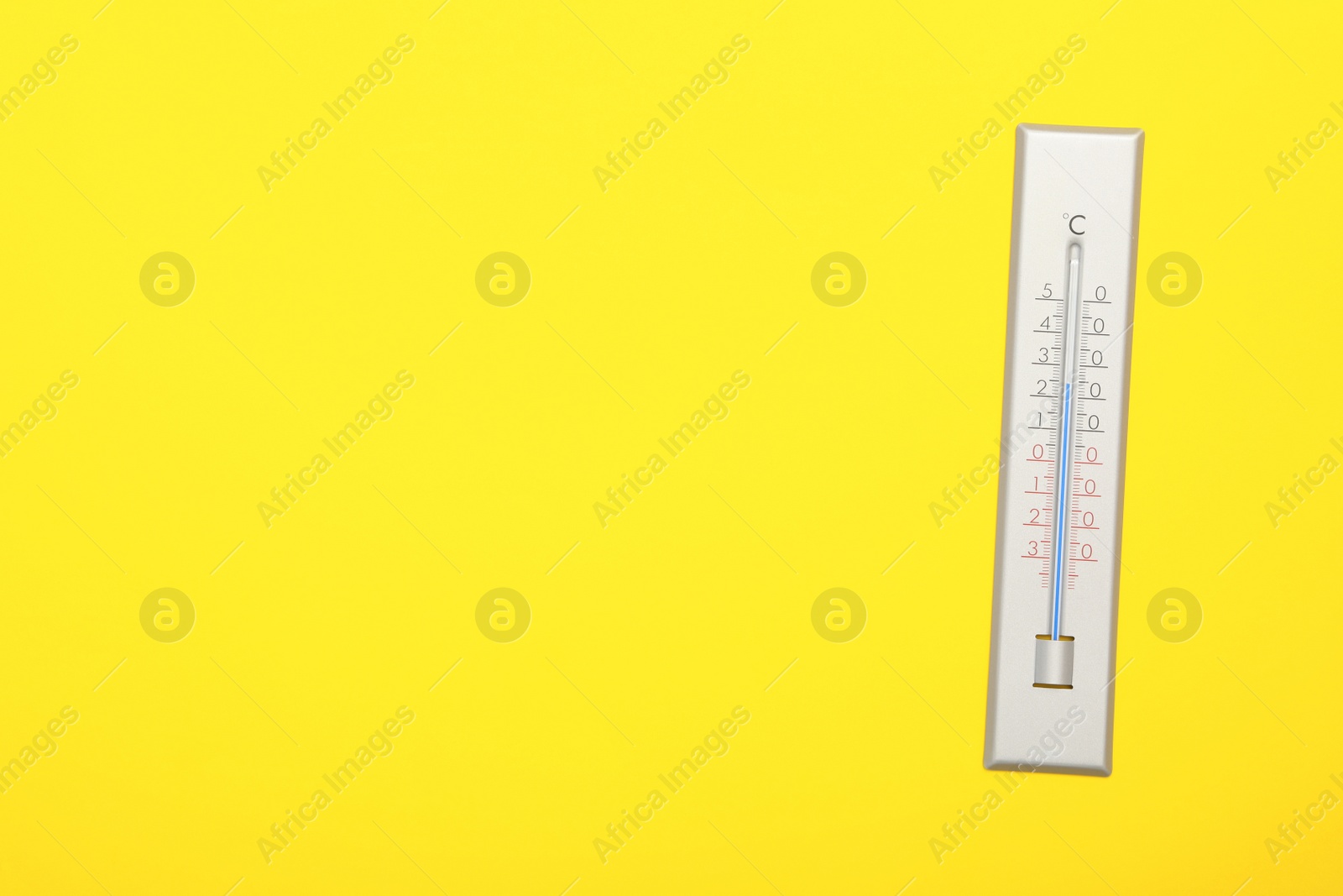 Photo of Weather thermometer on yellow background, top view. Space for text