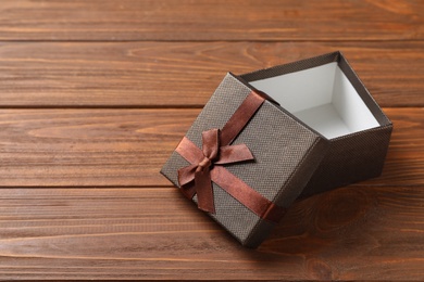 Empty open gift box on wooden background