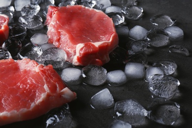 Raw meat and ice cubes on table