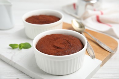 Photo of Delicious fresh chocolate fondant on white wooden table