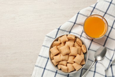 Photo of Bowl of sweet crispy corn pads and juice on white wooden table, flat lay with space for text. Breakfast cereal