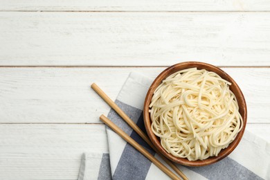 Photo of Tasty rice noodles on white wooden table, flat lay. Space for text