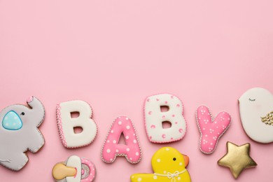 Photo of Word BABY and tasty cookies on pink background, flat lay. Space for text