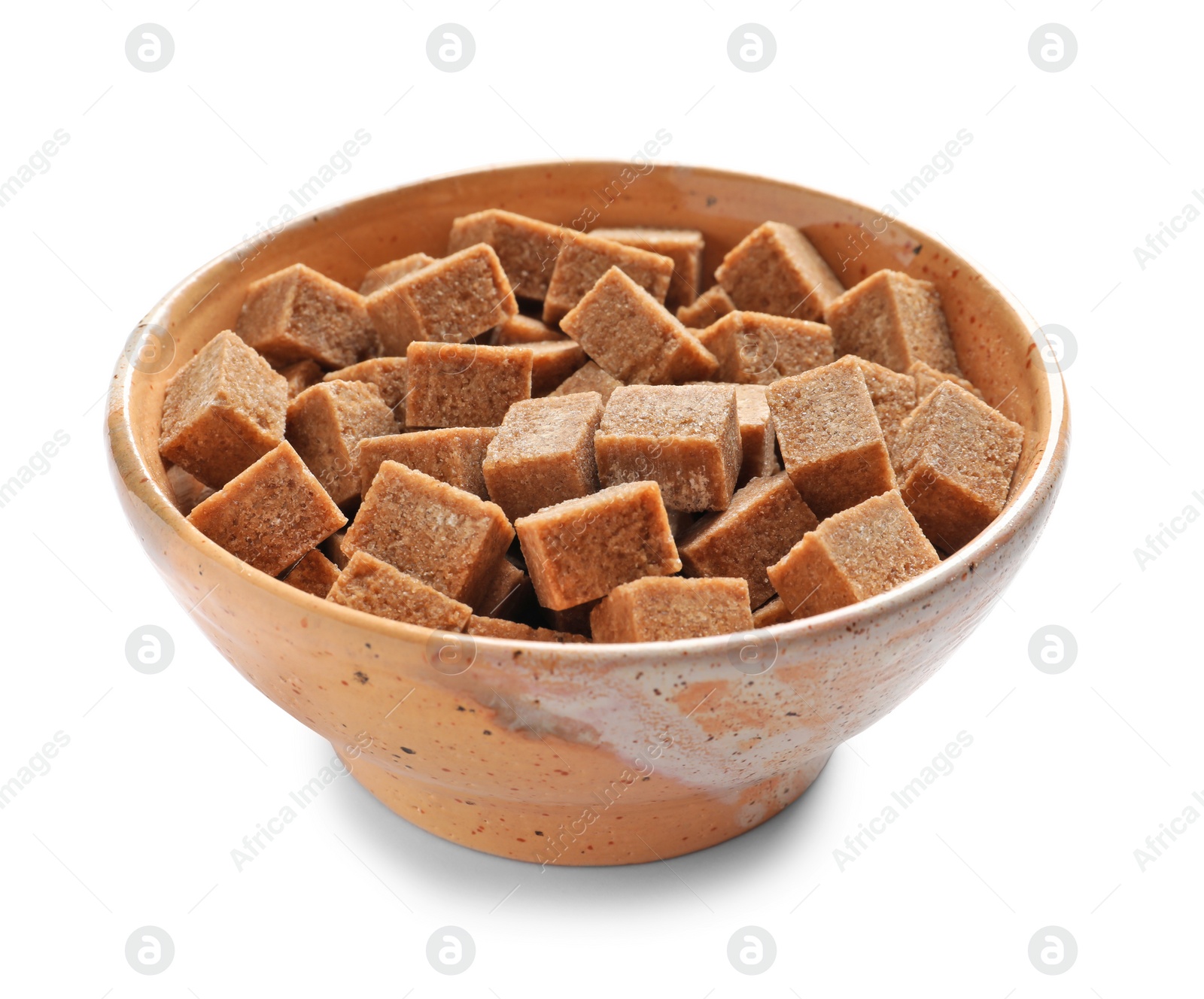 Photo of Bowl with cubes of brown sugar on white background