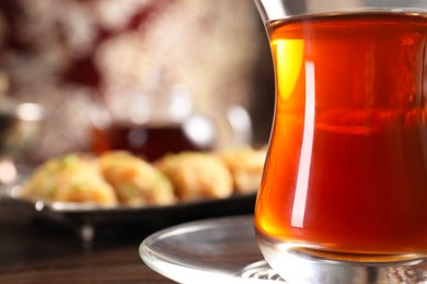 Photo of Traditional Turkish tea in glass on table, closeup. Space for text