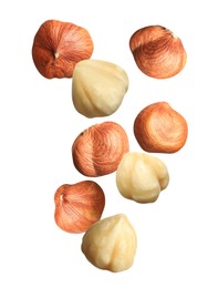 Image of Tasty hazelnuts falling on white background. Healthy snack