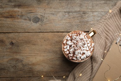 Photo of Cup of delicious hot cocoa with marshmallows on wooden table, flat lay. Space for text
