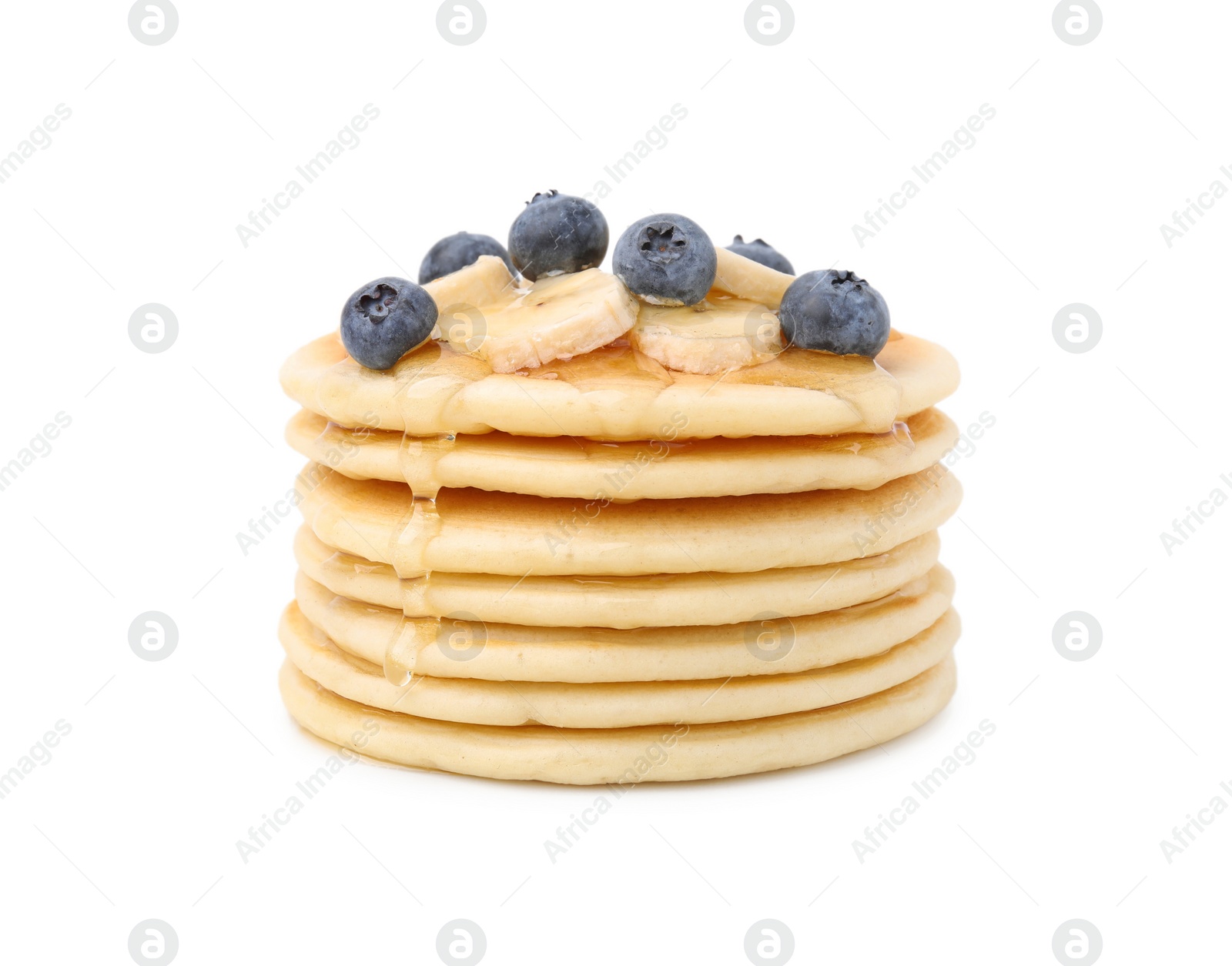 Photo of Delicious pancakes with banana slices, blueberries and honey isolated on white