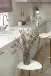 Photo of Beautiful blooming pussy willow branches in kitchen