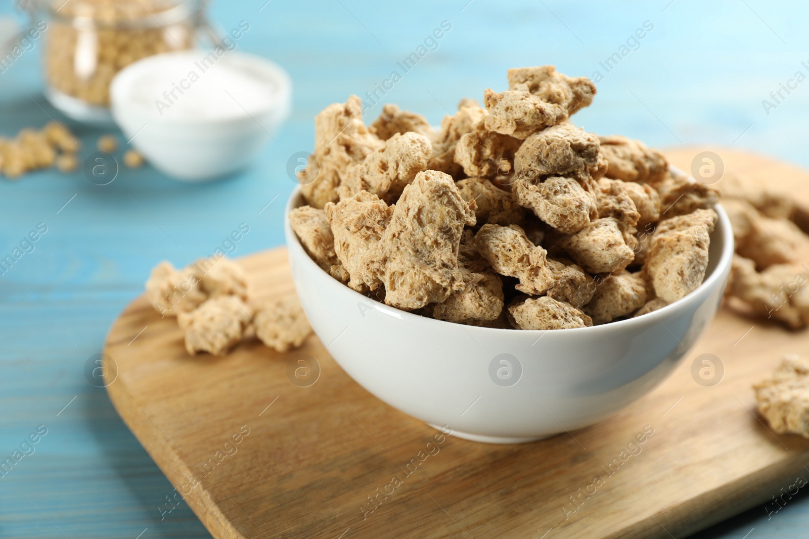 Photo of Dried soy meat on light blue wooden table, closeup