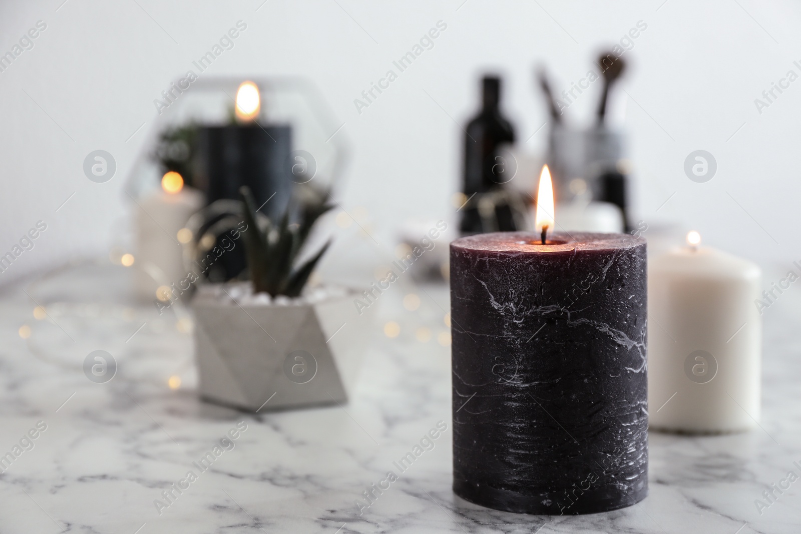 Photo of Burning candles on marble table, space for text