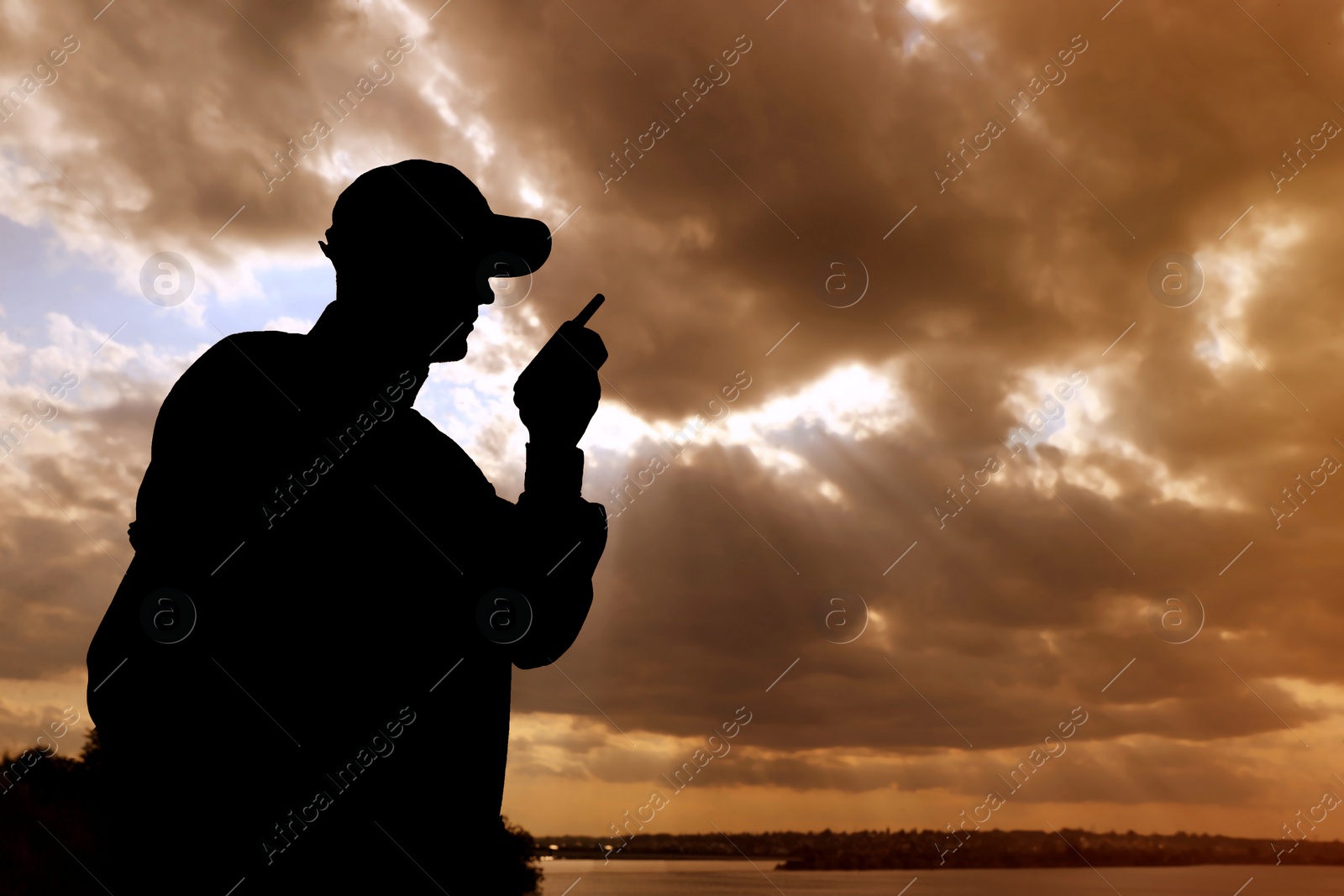 Photo of Soldier with portable radio transmitter outdoors. Military service