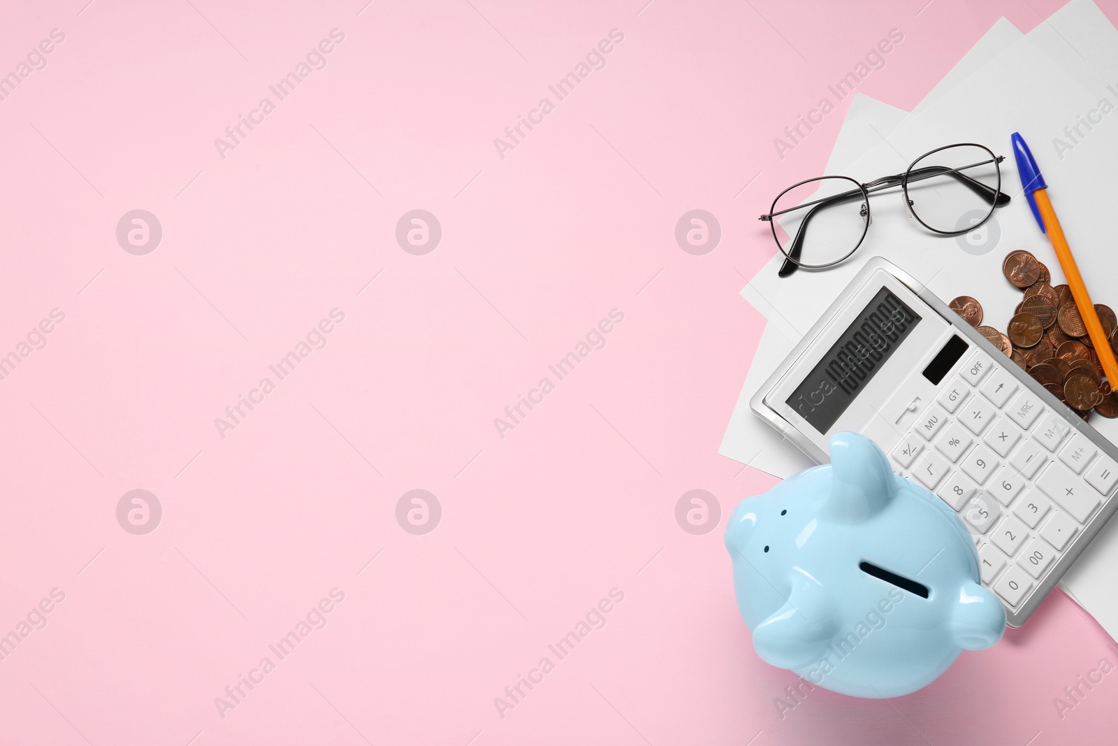 Photo of Flat lay composition with calculator and piggy bank on pink background. Space for text