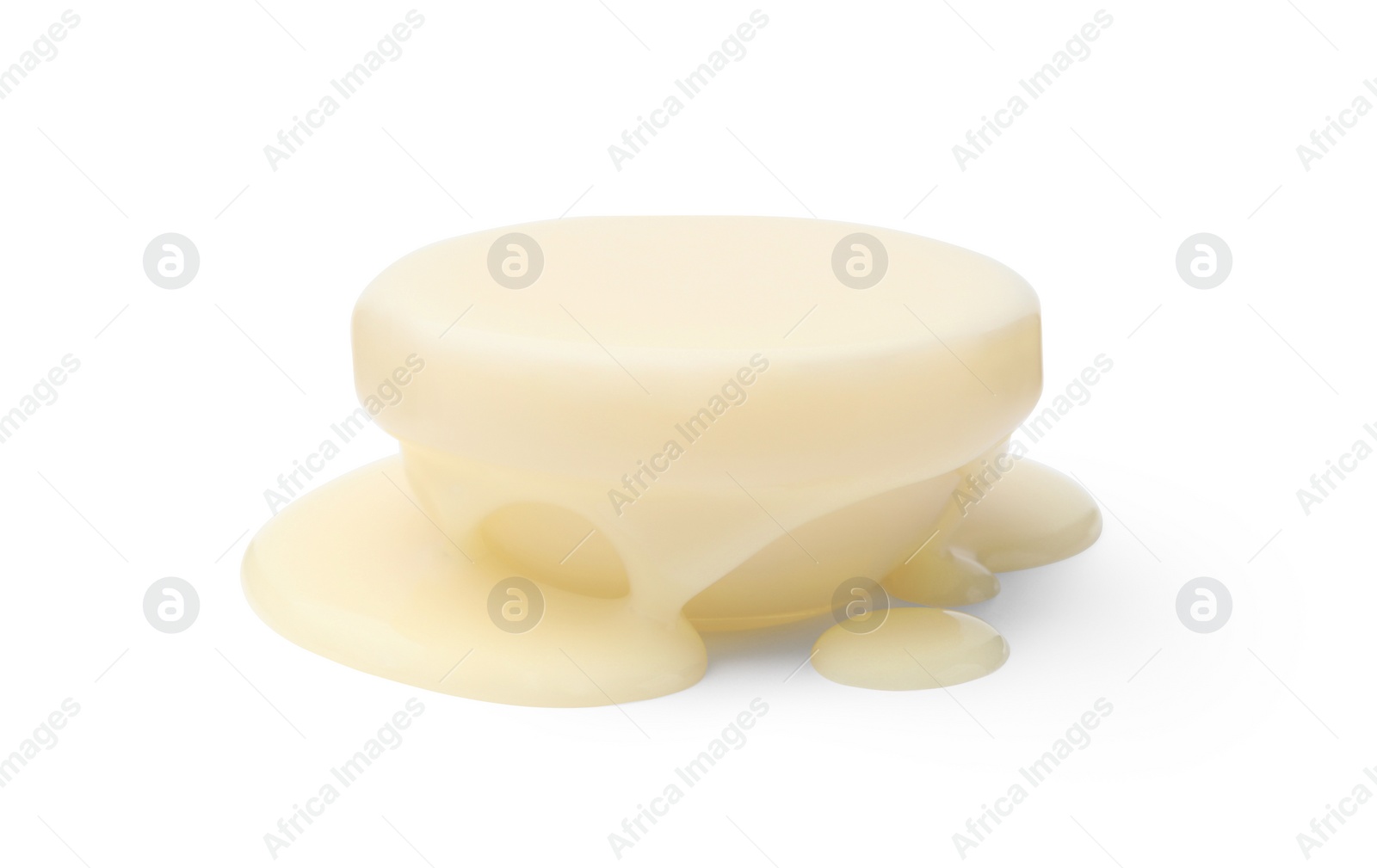 Photo of Glass bowl full of condensed milk isolated on white