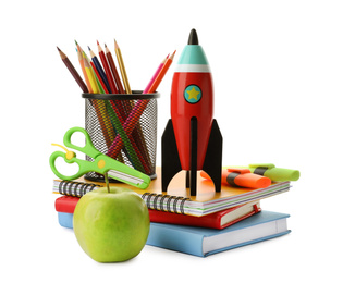 Photo of Bright toy rocket and school supplies on white background