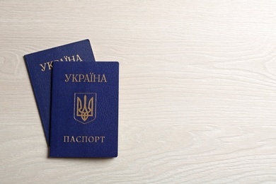 Photo of Ukrainian internal passports on wooden background, top view. Space for text