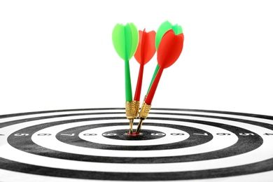 Photo of Arrows hitting target on dart board against white background