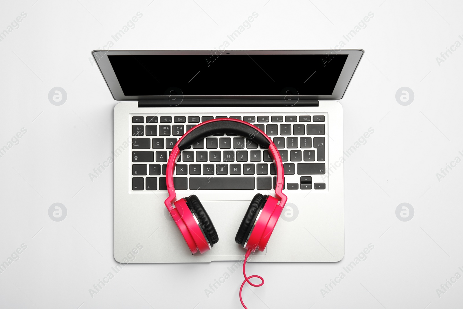 Photo of Modern headphones and laptop on white background, top view