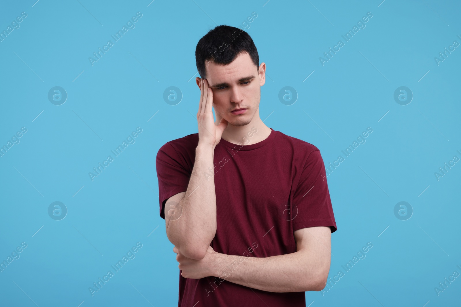 Photo of Portrait of sad man on light blue background