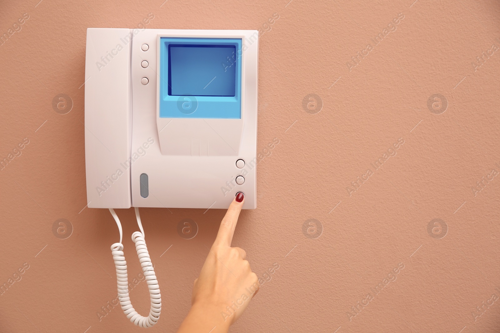 Photo of African-American woman pressing button on intercom panel indoors, closeup. Space for text