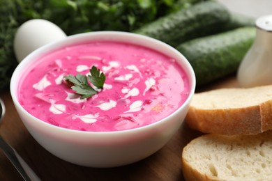 Delicious cold summer beet soup on wooden board, closeup