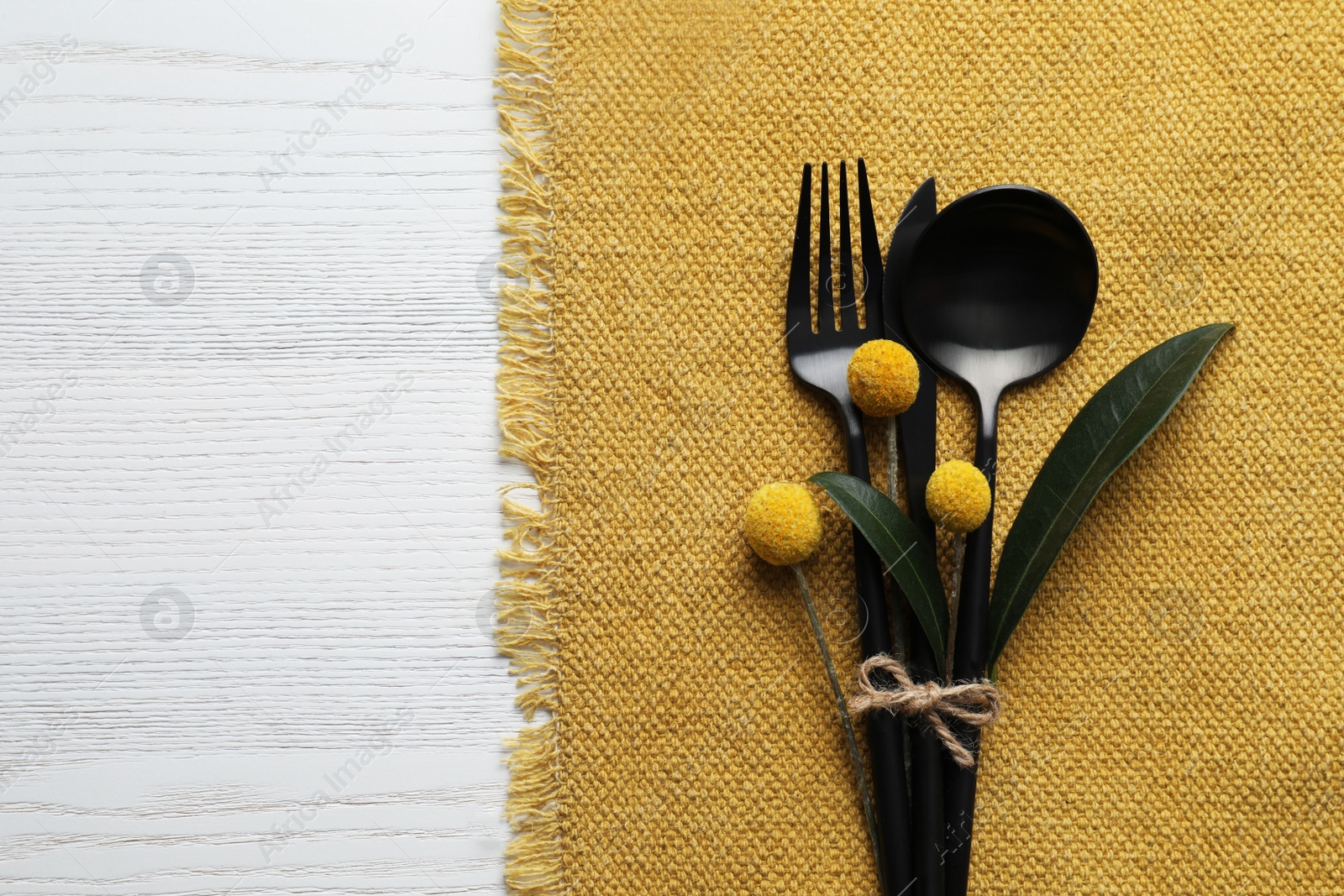 Photo of Top view of autumn place setting with cutlery on white wooden table, space for text