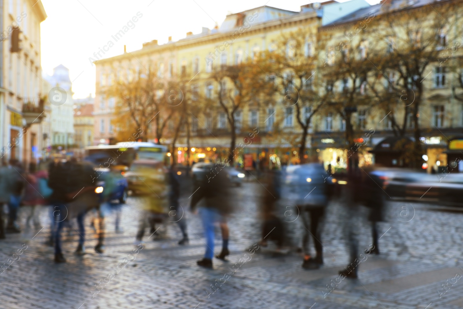 Photo of Blurred view of people crossing street in city