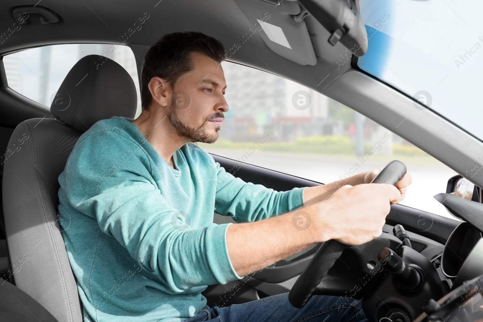 Photo of Sleepy tired man driving his modern car