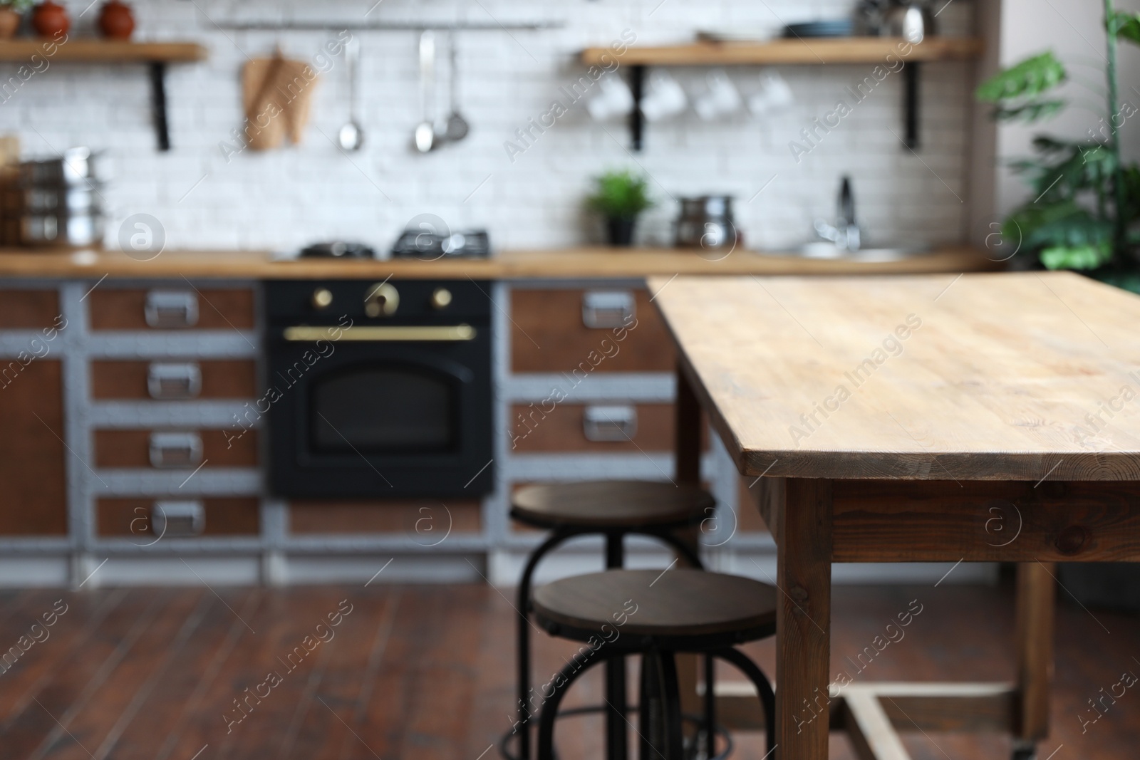 Photo of Empty wooden table in beautiful kitchen. Interior design