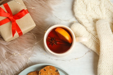 Photo of Flat lay composition with cup of hot mulled wine on white table. Winter drink