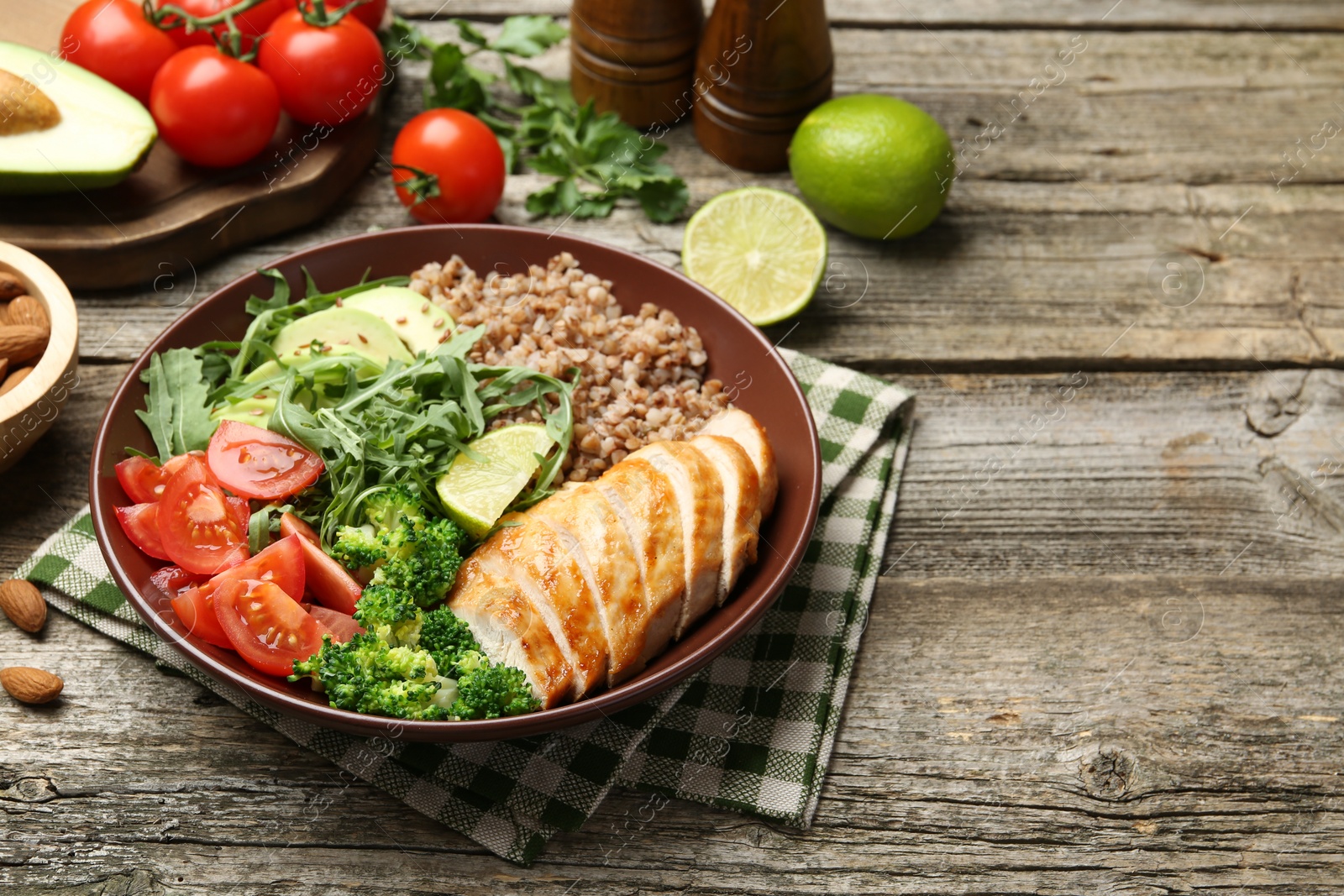 Photo of Healthy meal. Tasty products in bowl on wooden table, space for text