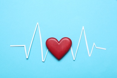 Photo of Paper cardiogram line and red heart on light blue background, flat lay