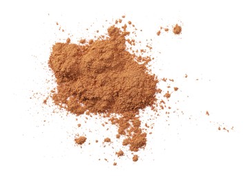 Photo of Dry aromatic cinnamon powder isolated on white, top view
