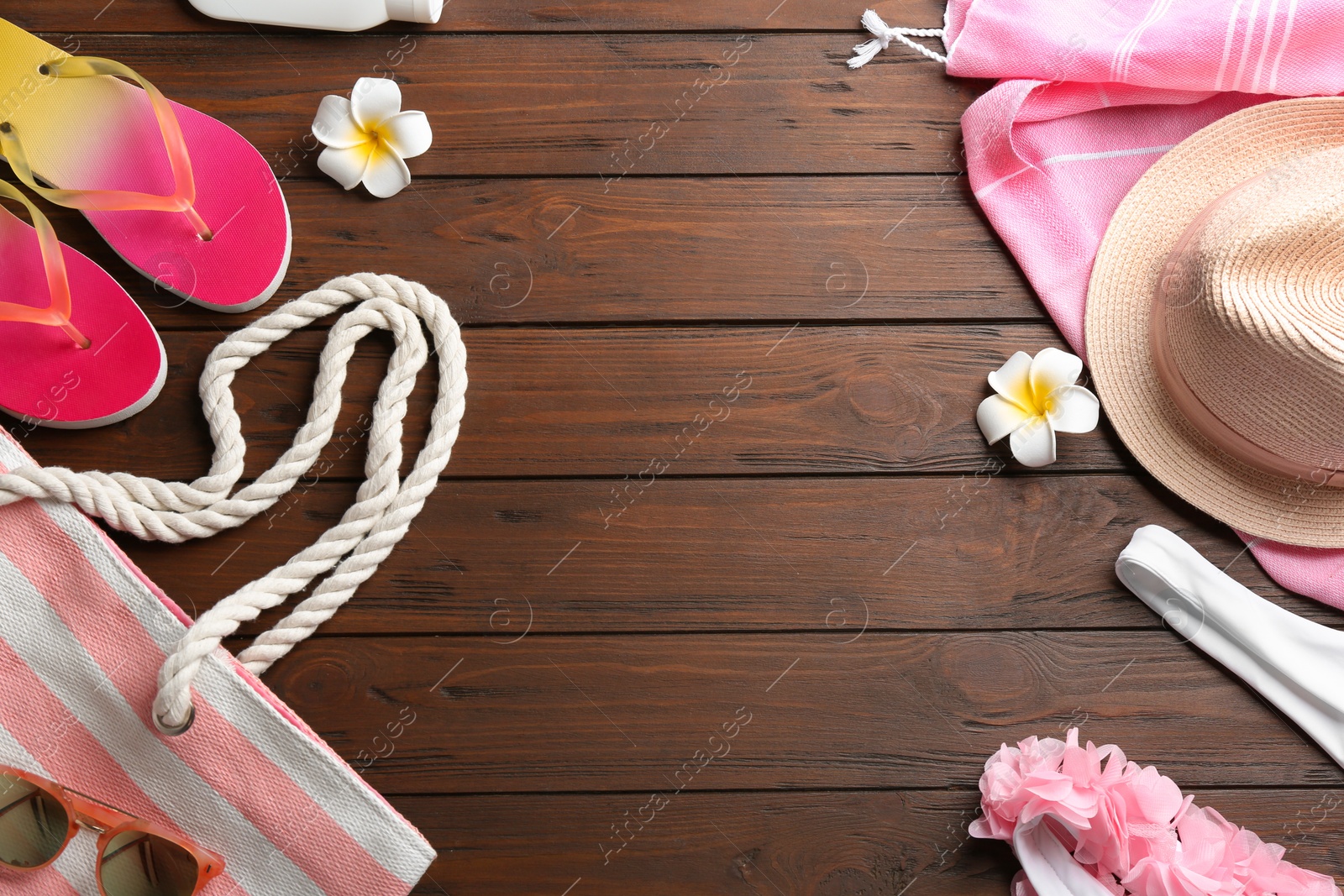 Photo of Flat lay composition with beach accessories on wooden background. Space for text