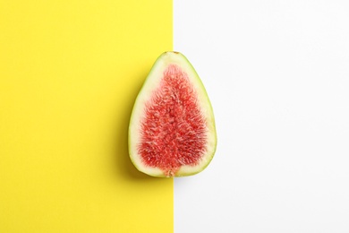 Photo of Fresh ripe fig slice on color background, top view